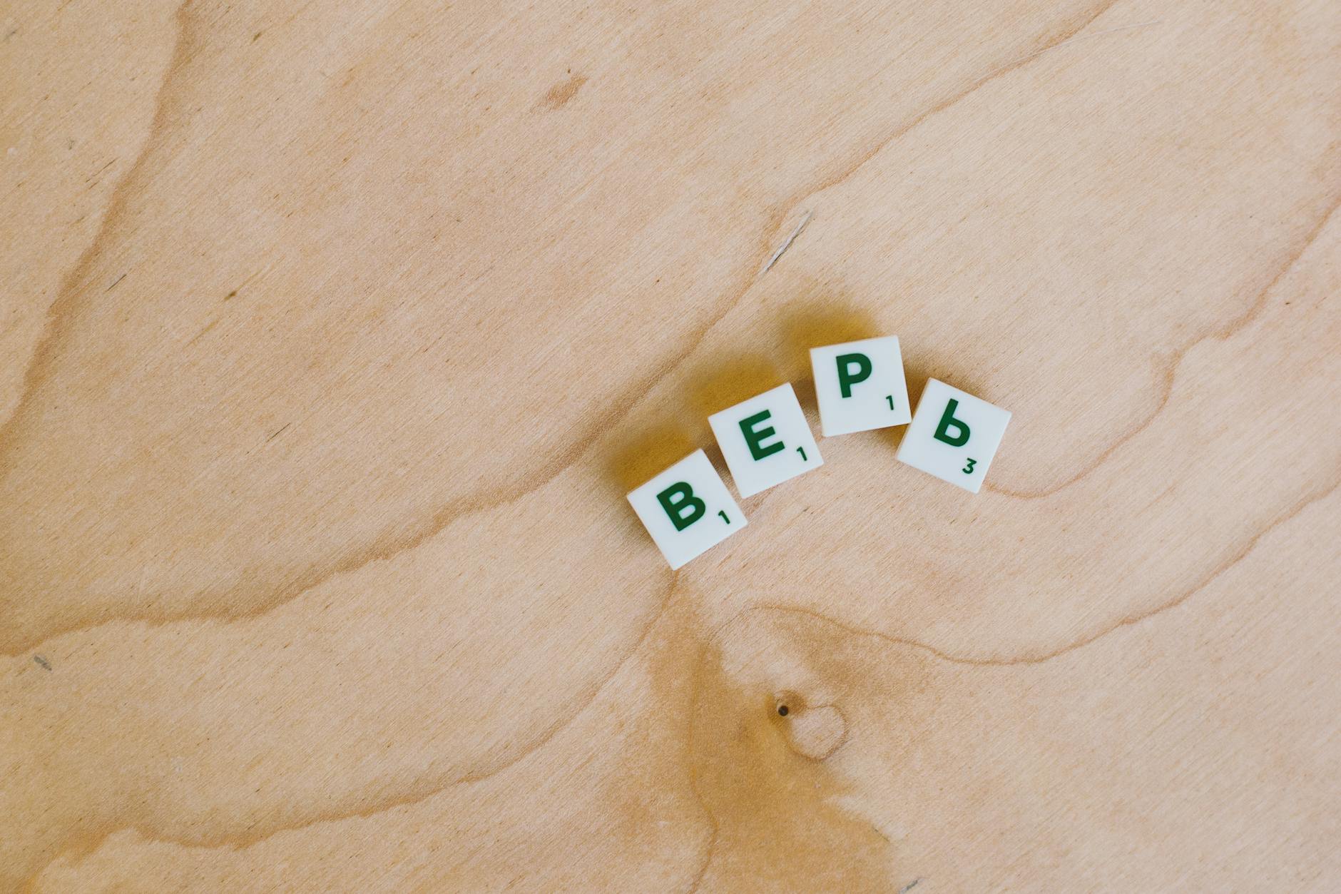 Kafle z literami cyrylicy układające słowo na drewnianej powierzchni